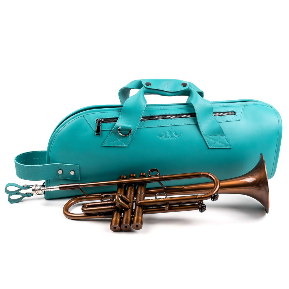 Handmade Tiffany blue leather trumpet gig bag crafted from Crazy Horse leather with detachable black strap, placed with a silver trumpet in front of the case