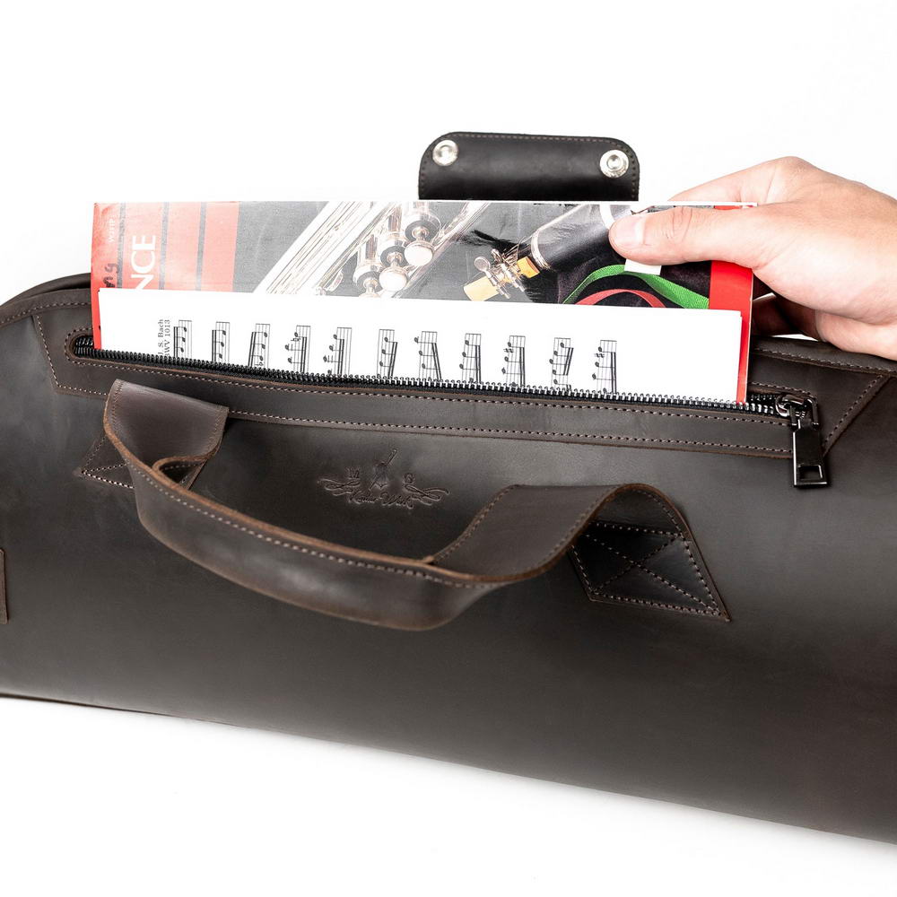 Trumpet gig bag Crazy Horse leather brown with side pocket holding A4 sheet music, durable zipper and front handle visible.
