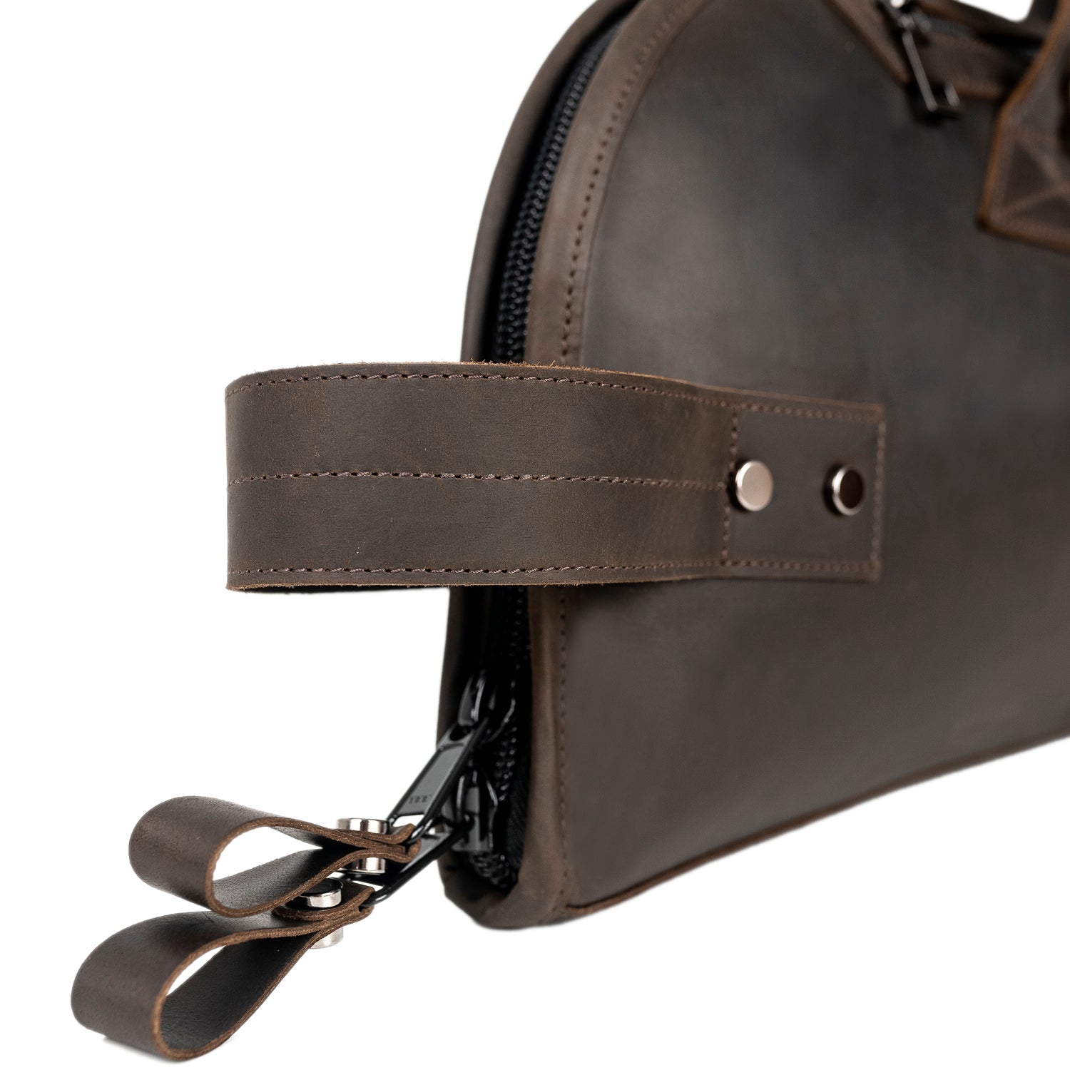 Side view of Trumpet Gig Bag in Crazy Horse brown leather showing reinforced vertical carry handle and two YKK zipper pullers for secure closure.