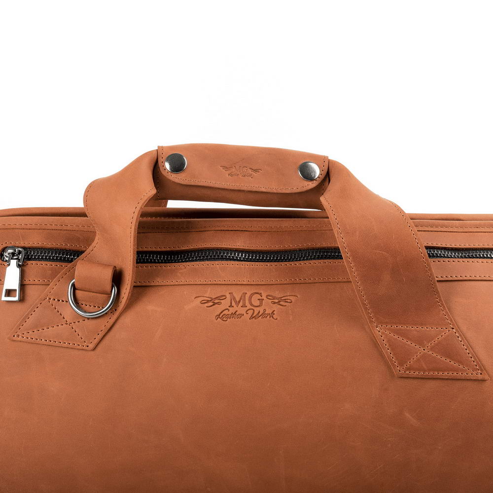 Trumpet case Crazy Horse leather light brown close-up view with MG Leather Work logo, handles, and side zipper pocket