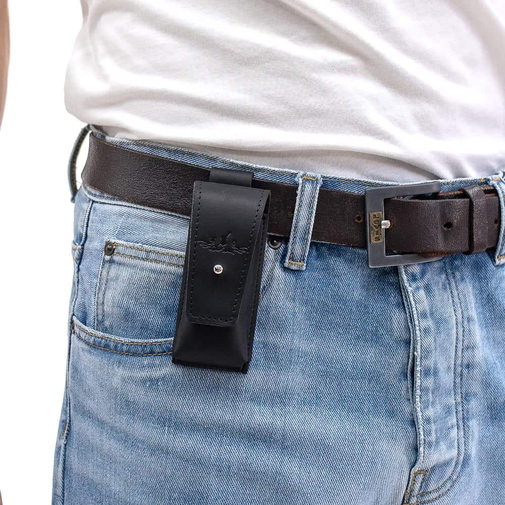 Black leather harmonica holster attached to black leather belt over jeans