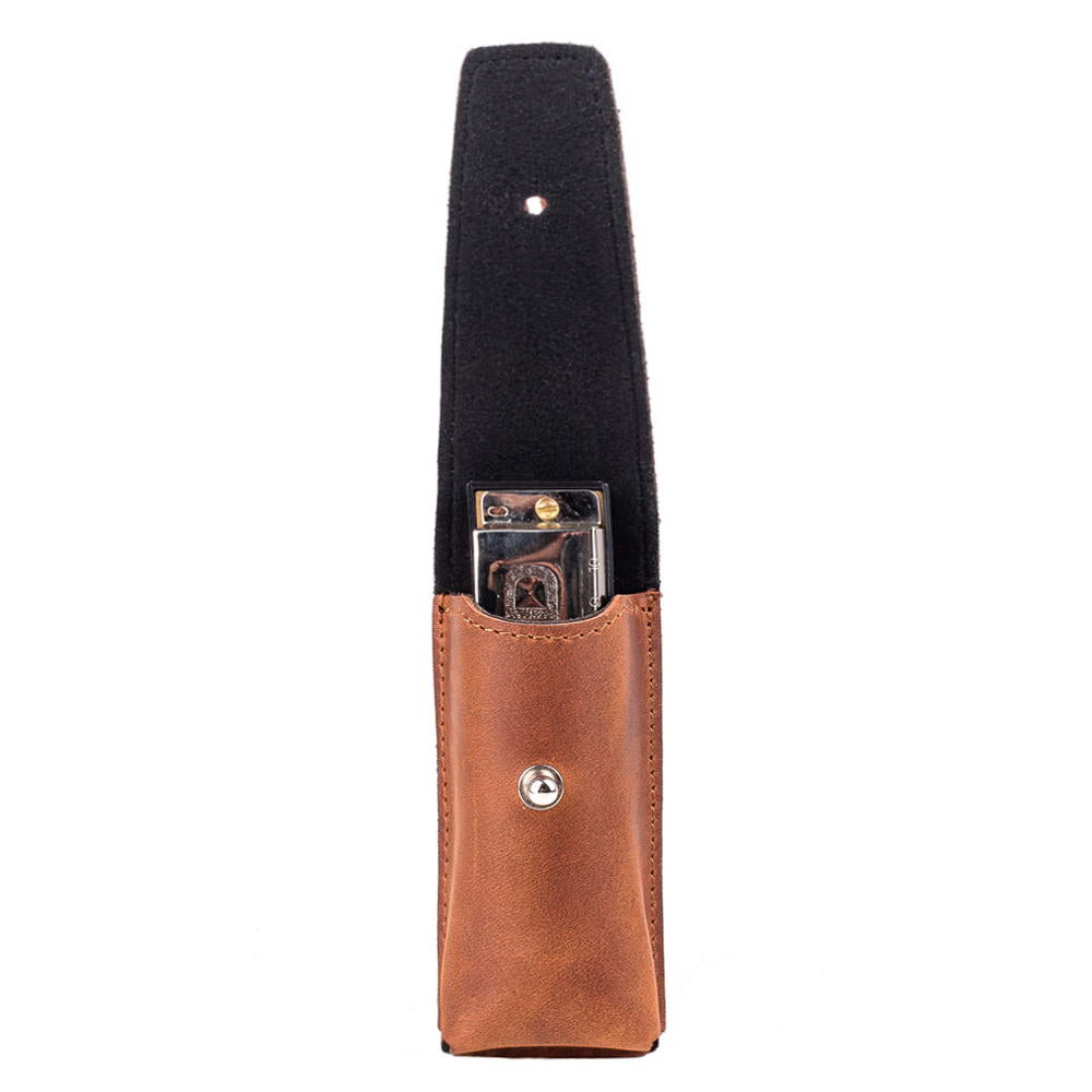close-up of light brown leather harmonica case featuring metal holster clasp