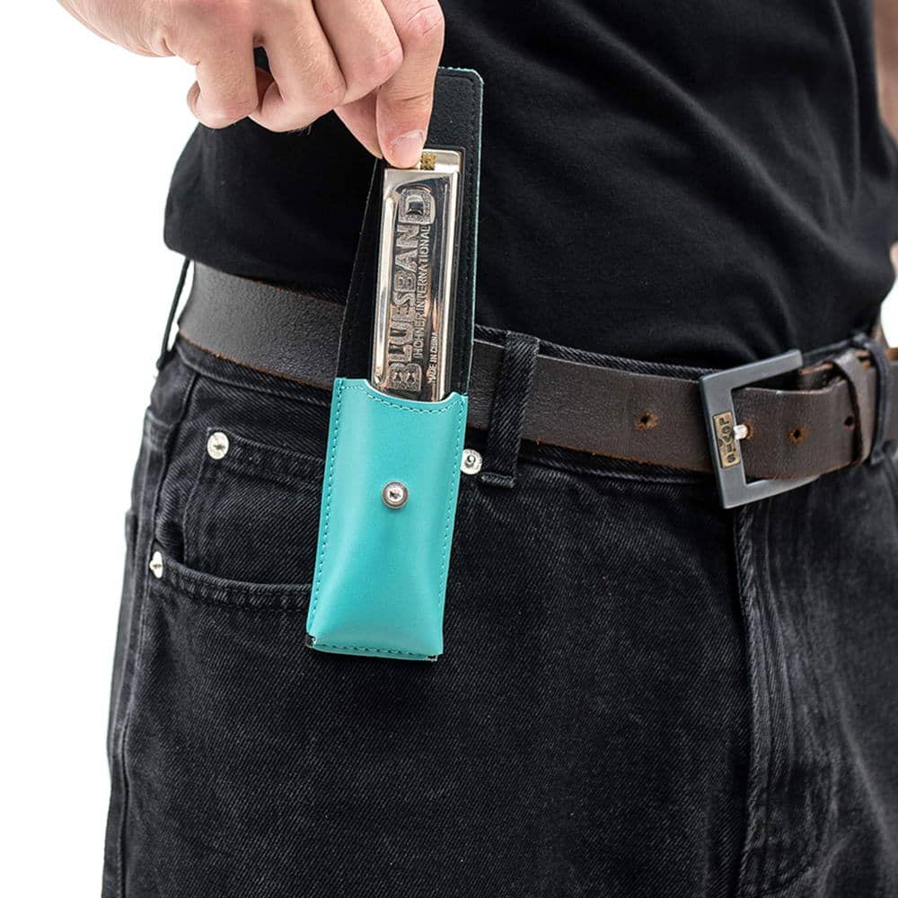 Man pulling harmonica from tiffany leather holder on belt