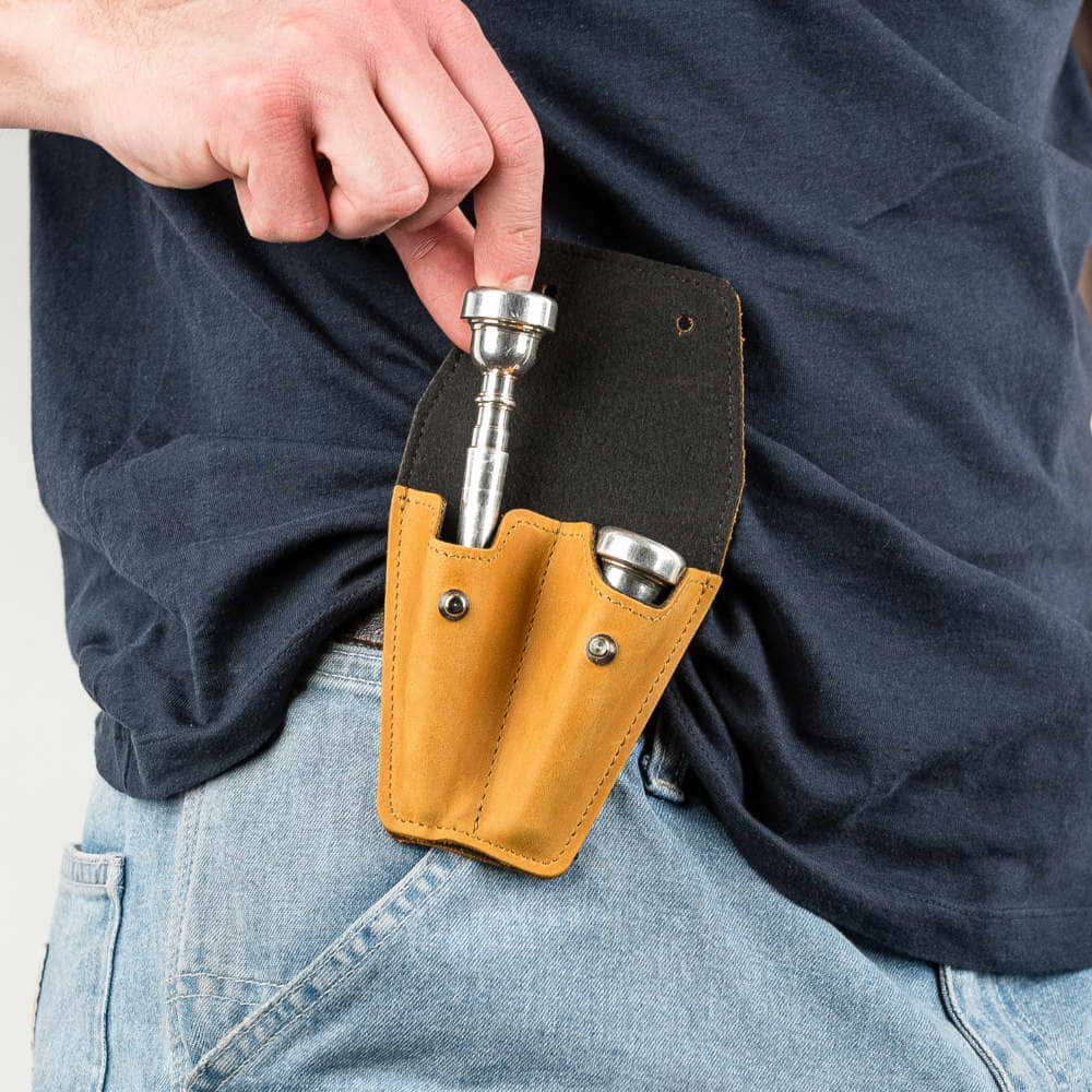 Trumpet double mouthpiece holder in yellow Crazy Horse leather — musician removing mouthpiece
