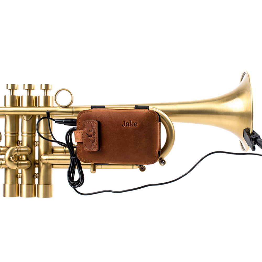 Side angle of a trumpet with leather microphone pouch and connected cable.