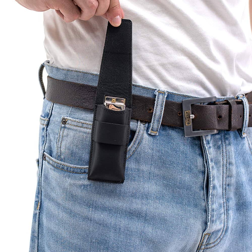 Black leather harmonica holster with open flap showing harmonica inside.
