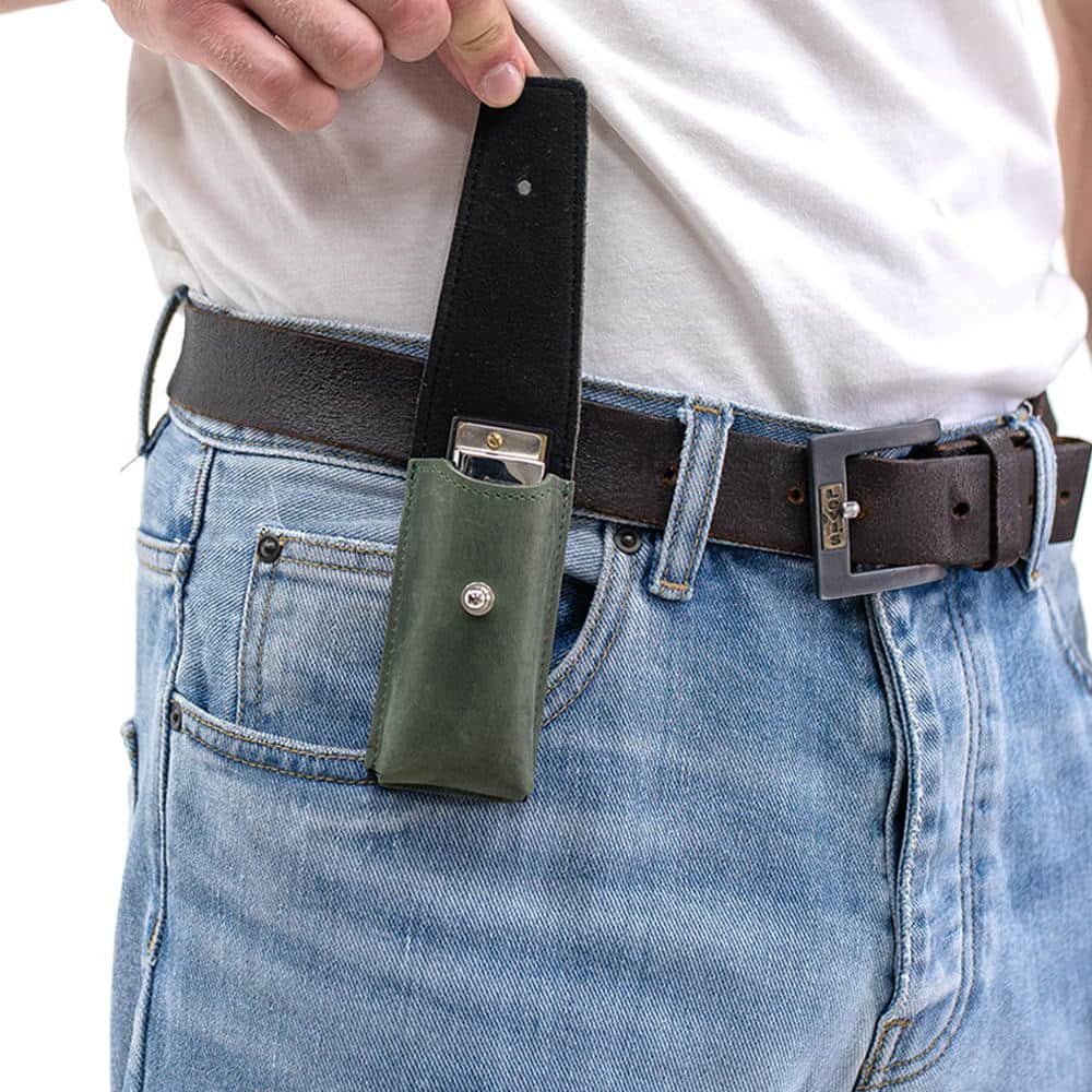 Green leather harmonica case on belt with flap open revealing harmonica.