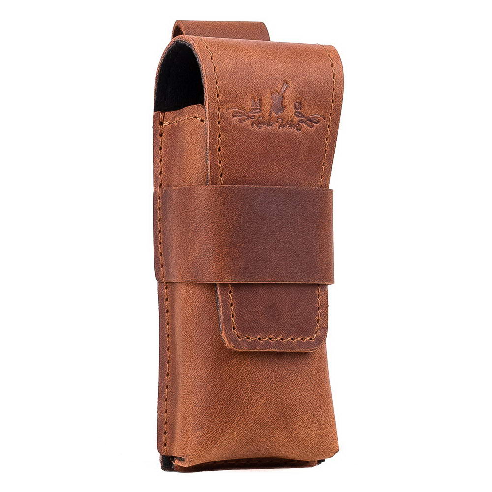 Angled shot of light brown leather harmonica holster with snap closure.
