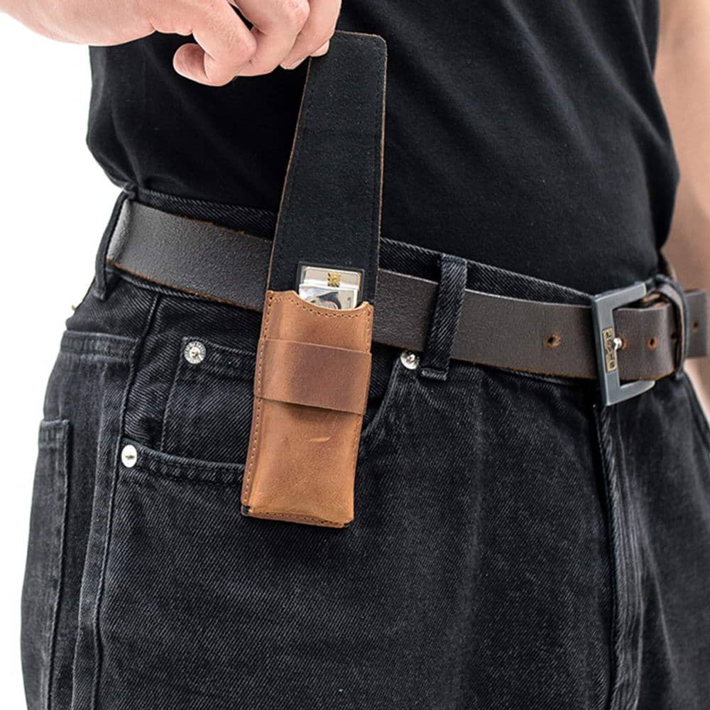 Light brown leather harmonica holster with open flap and visible harmonica.