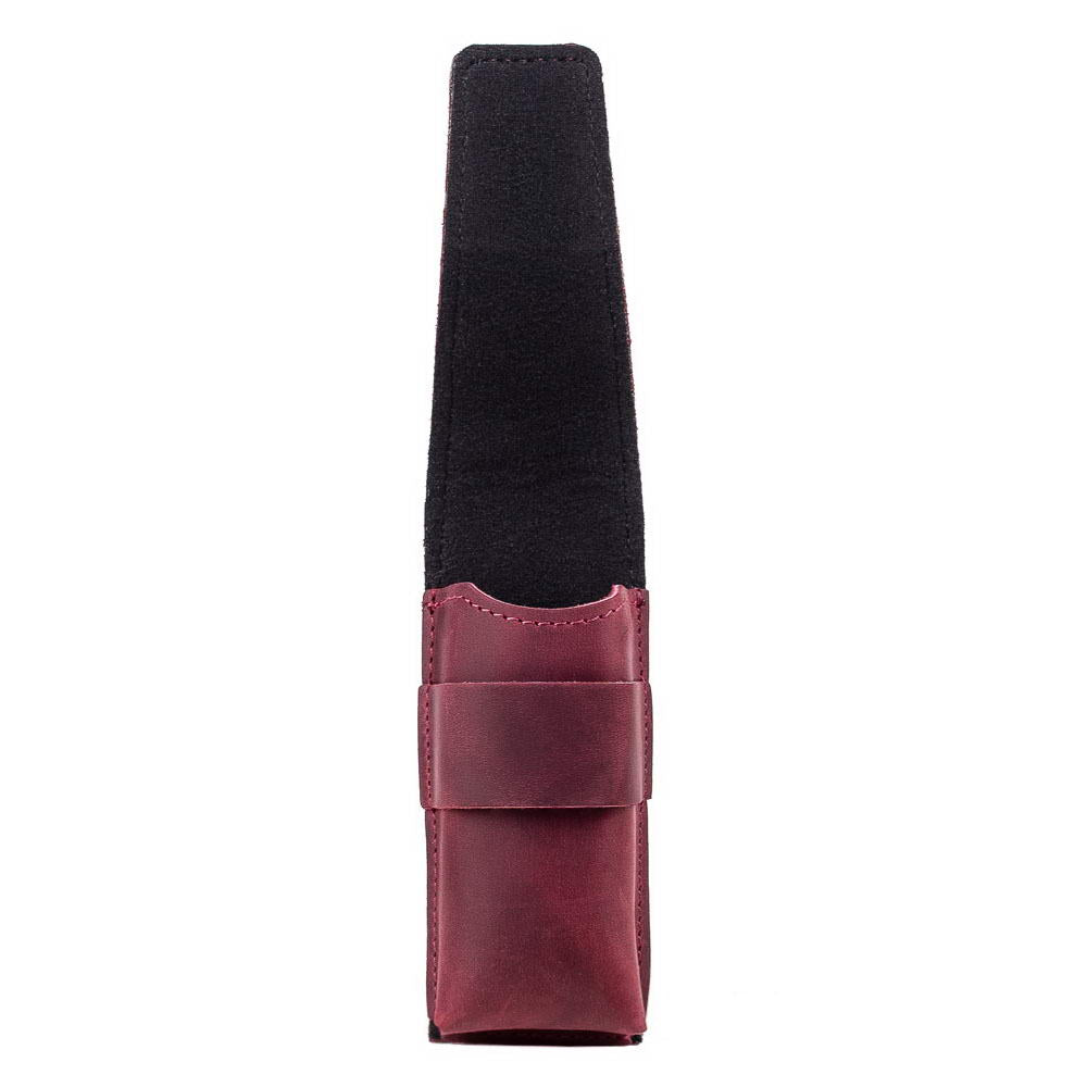 Side view of marsala harmonica leather holder with flap lifted to reveal interior.