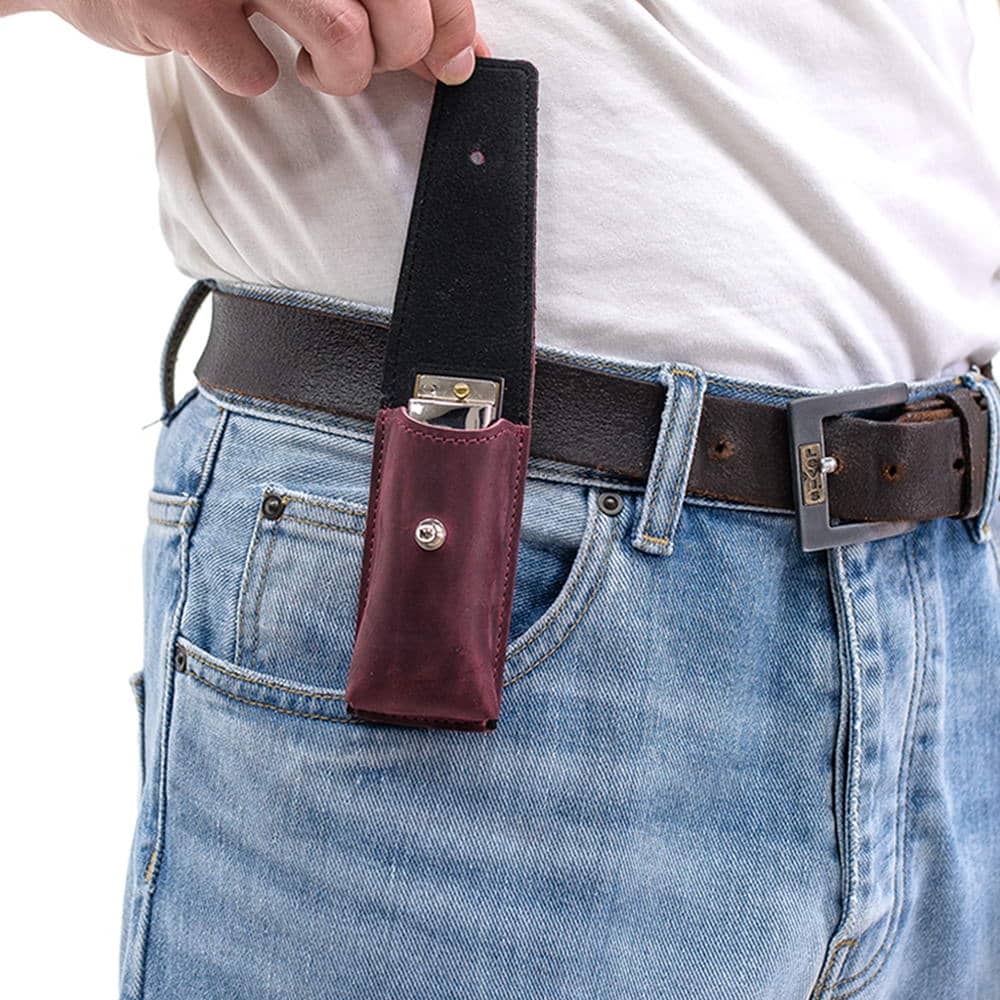 Marsala leather harmonica case on belt with open flap showing harmonica inside.
