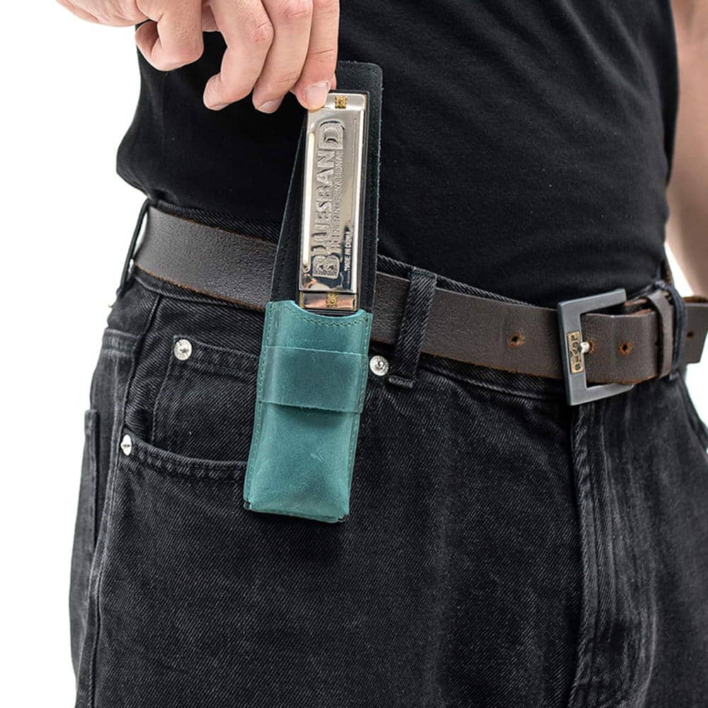 Opal harmonica pouch on belt as harmonica is taken out by hand.