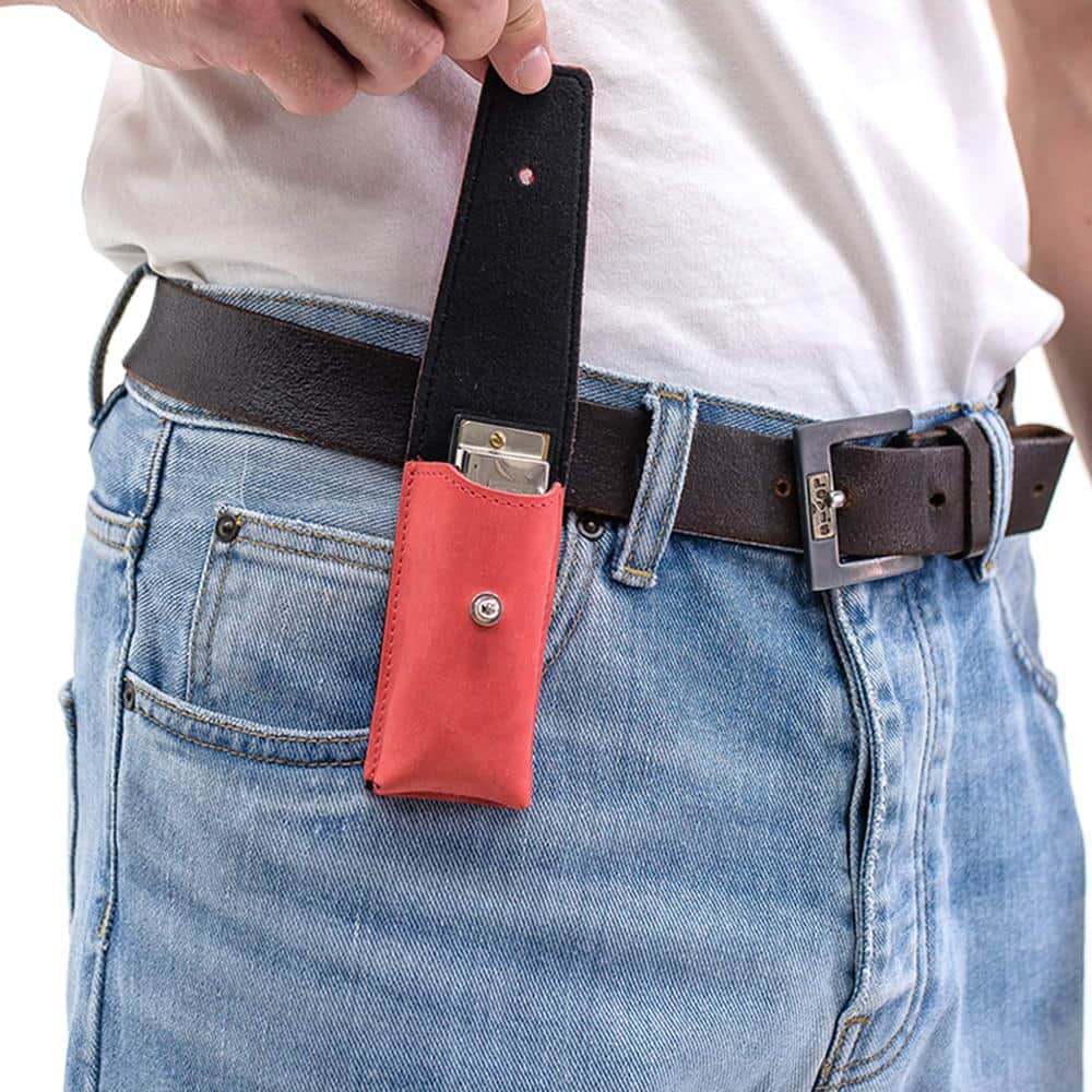 Red leather harmonica case on belt with open flap showing harmonica inside