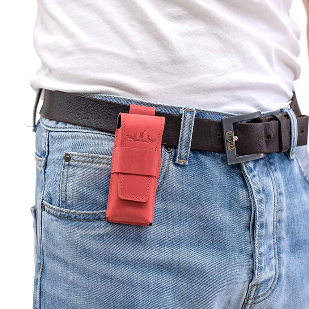 Red leather harmonica case mounted on black belt with denim outfit.