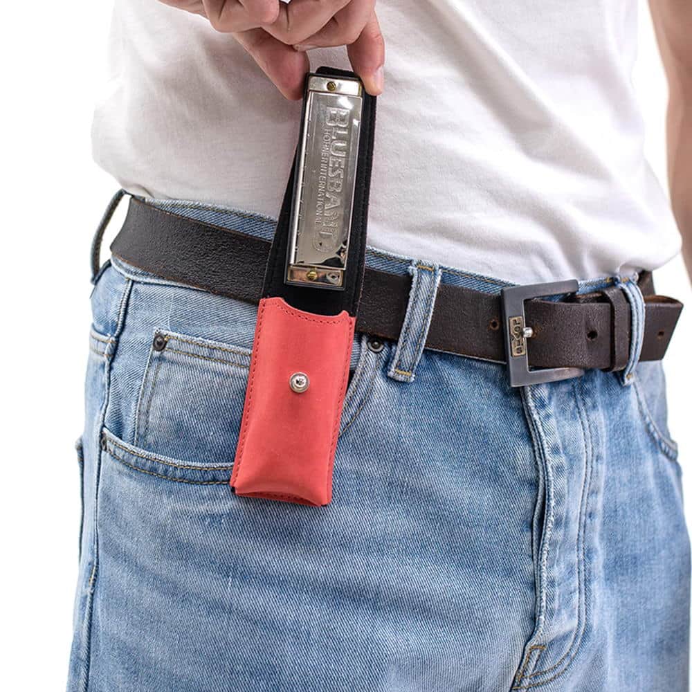 Red harmonica leather holder on belt with harmonica being removed by hand