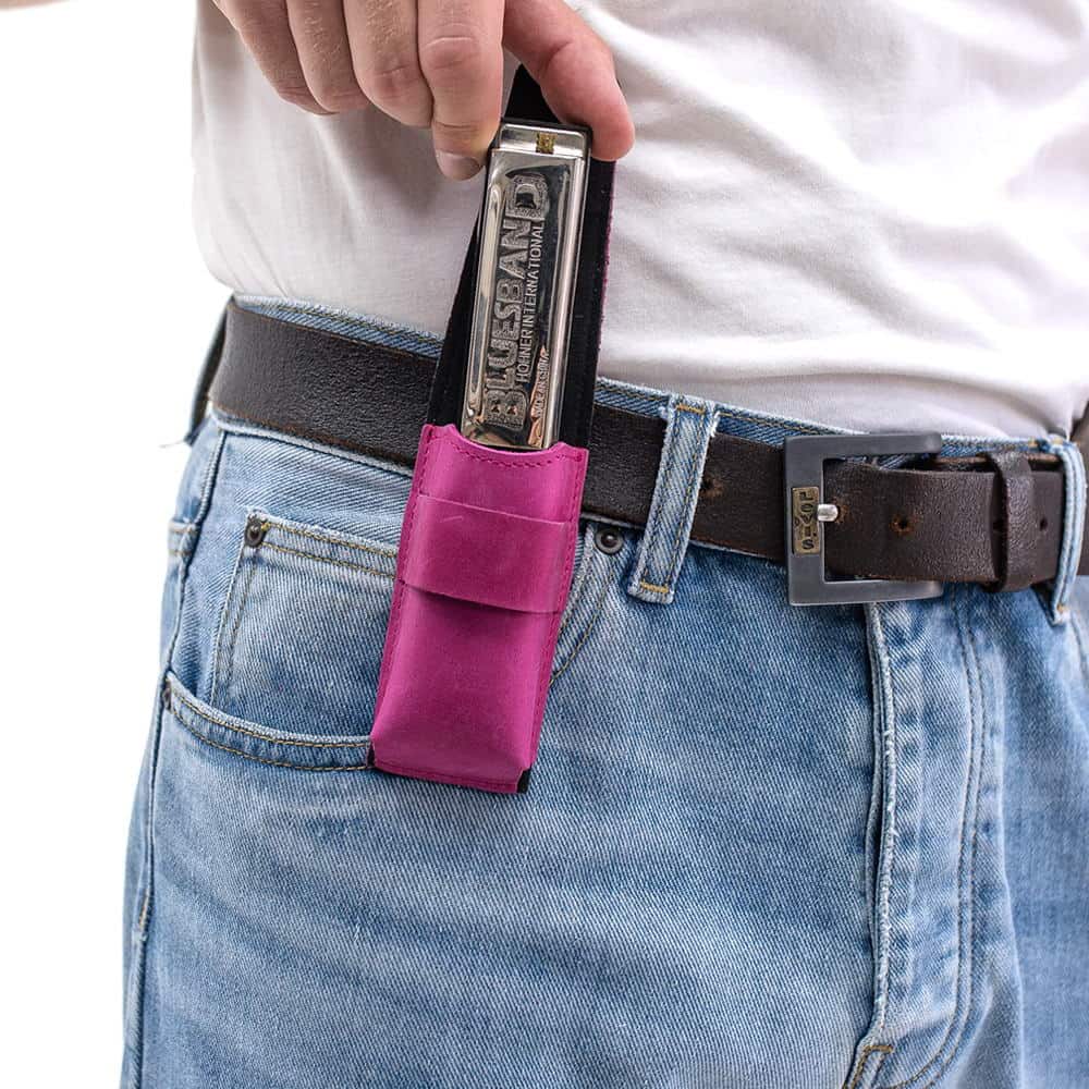 Rose leather harmonica case holding harmonica, flap open for easy access.