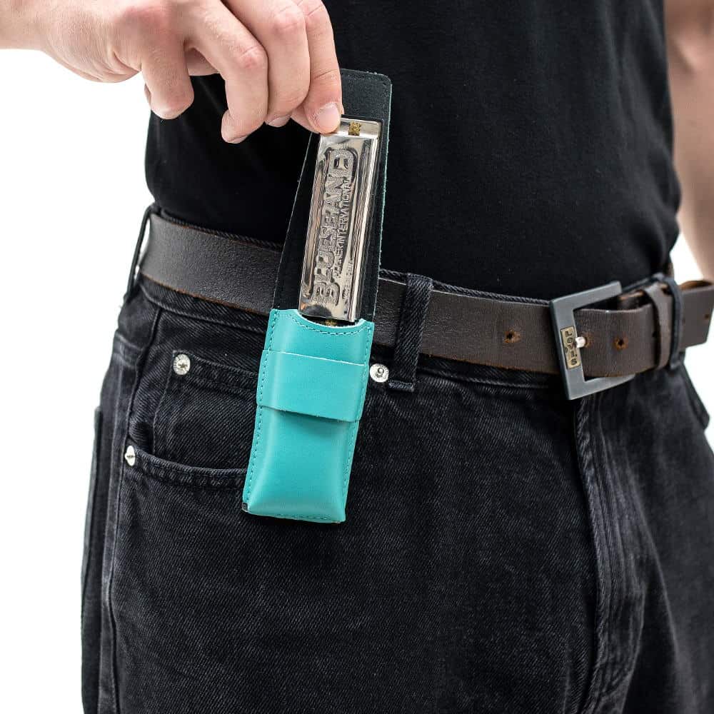 Tiffany harmonica leather pouch on belt as harmonica is removed.