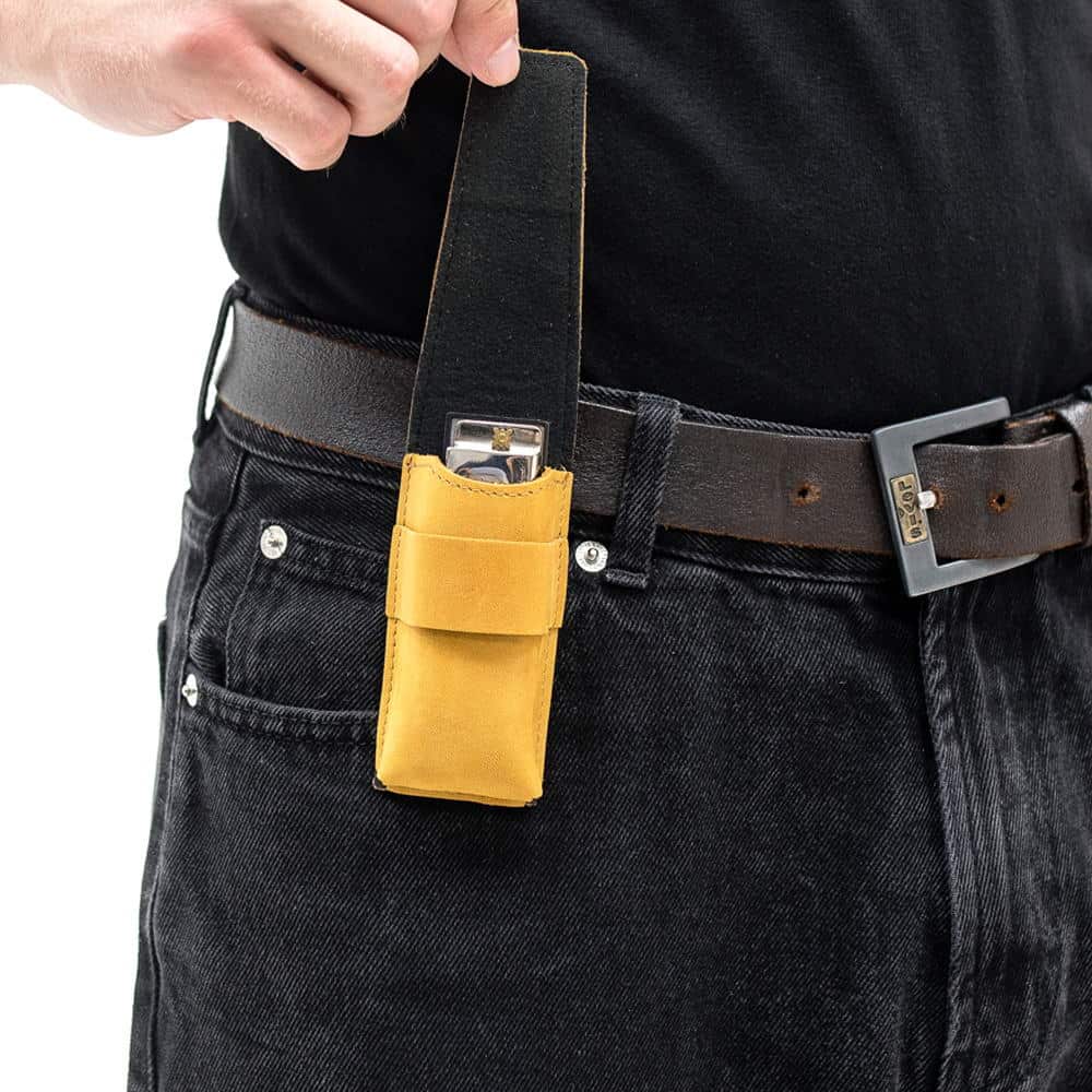 Yellow harmonica holster with belt clip and open flap revealing harmonica.